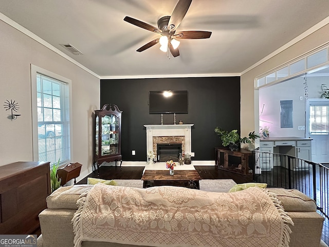6192 Collins St NE, Covington, GA 30014 - living room featuring a ceiling fan, plenty of natural light, wood finished floors, crown molding, and a glass covered fireplace