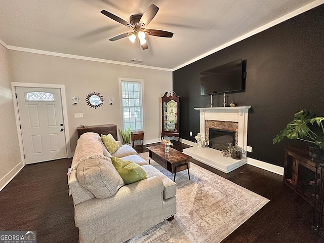 6192 Collins St NE, Covington, GA 30014 - living area with ceiling fan, ornamental molding, a stone fireplace, and wood finished floors