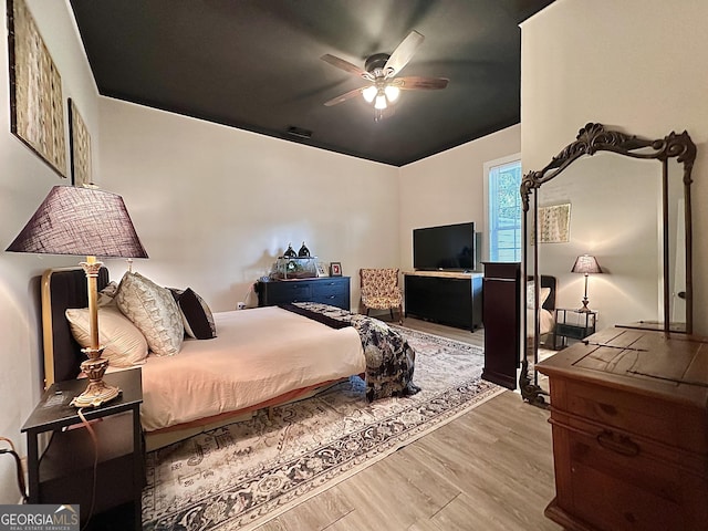 6192 Collins St NE, Covington, GA 30014 - bedroom featuring wood finished floors, vaulted ceiling, and a ceiling fan