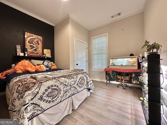 6192 Collins St NE, Covington, GA 30014 - bedroom with wood finished floors and ornamental molding