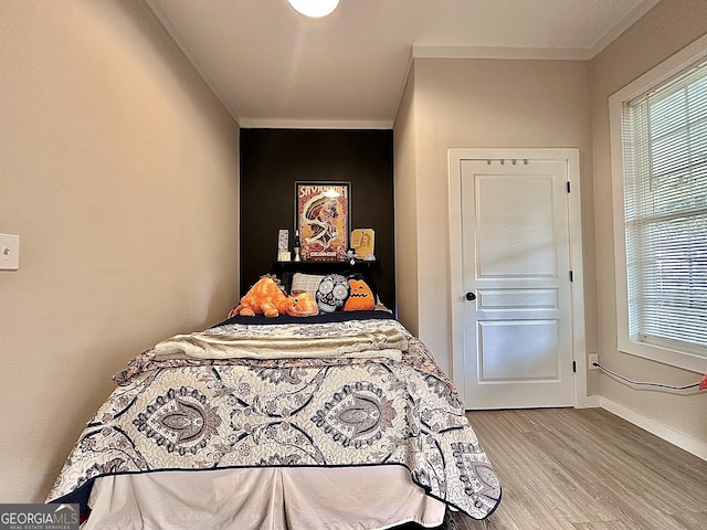 6192 Collins St NE, Covington, GA 30014 - bedroom with light wood finished floors and crown molding