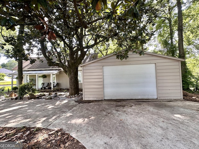 6192 Collins St NE, Covington, GA 30014 - detached garage with concrete driveway and covered porch