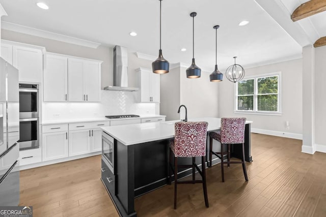 6080 Simone St, Acworth, GA 30101 - kitchen with wall chimney exhaust hood, stainless steel appliances, light countertops, decorative backsplash, and an island with sink