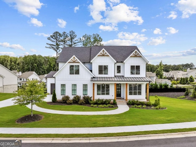 6080 Simone St, Acworth, GA 30101 - modern farmhouse style home with board and batten siding, a front yard, covered porch, a standing seam roof, and a metal roof