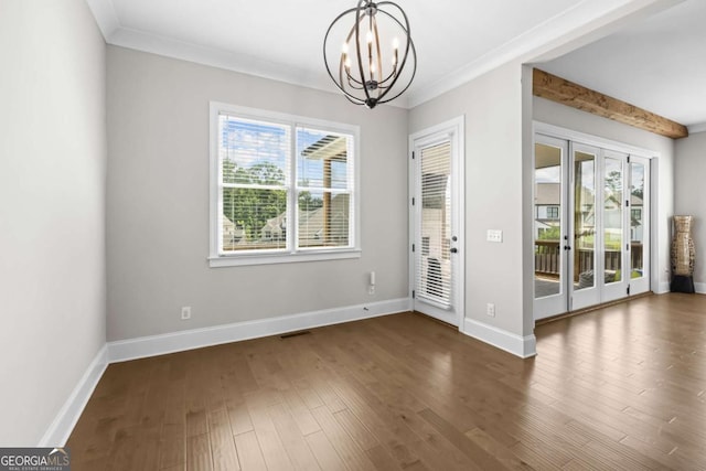 6080 Simone St, Acworth, GA 30101 - unfurnished dining area with a chandelier, healthy amount of natural light, crown molding, and wood finished floors