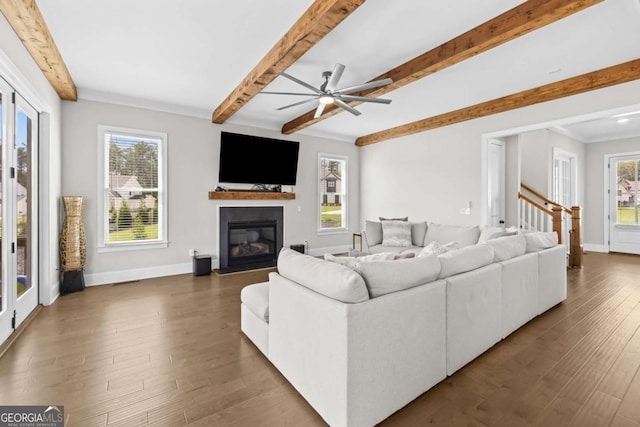 6080 Simone St, Acworth, GA 30101 - living area with beam ceiling, ceiling fan, dark wood finished floors, plenty of natural light, and a glass covered fireplace