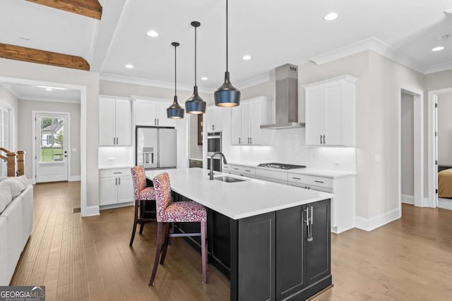 6080 Simone St, Acworth, GA 30101 - kitchen with wall chimney range hood, stainless steel appliances, a large island with sink, light countertops, and ornamental molding