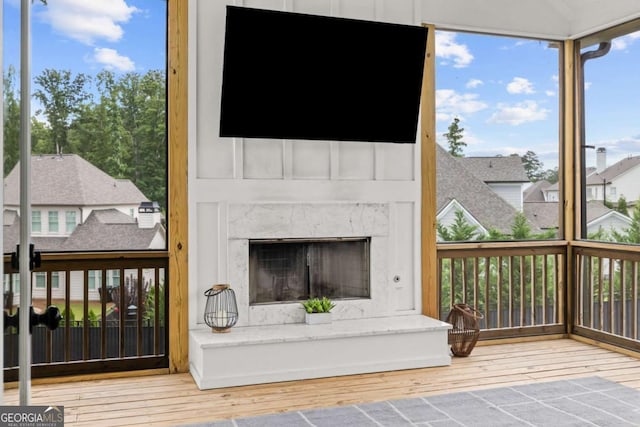 6080 Simone St, Acworth, GA 30101 - unfurnished living room with wood finished floors, healthy amount of natural light, and a fireplace with raised hearth