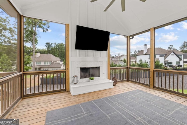 6080 Simone St, Acworth, GA 30101 - unfurnished sunroom with a fireplace, a residential view, ceiling fan, healthy amount of natural light, and vaulted ceiling