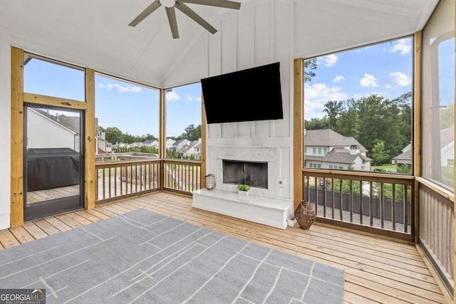 6080 Simone St, Acworth, GA 30101 - unfurnished sunroom featuring a fireplace with raised hearth, a ceiling fan, vaulted ceiling, and a residential view