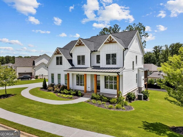 6080 Simone St, Acworth, GA 30101 - modern inspired farmhouse with board and batten siding, a porch, a front yard, a standing seam roof, and a metal roof