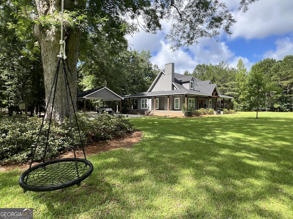 1030 Marley Cannon Rd, Dublin, GA 31021 - rear view of house with a chimney, a yard, a carport, and a porch
