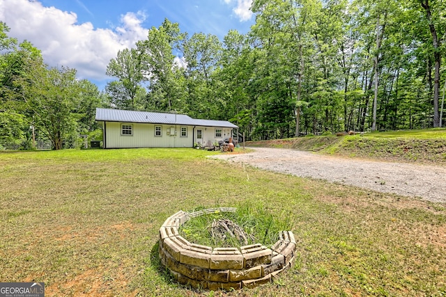 11 Hamilton Cir, Blairsville, GA 30512 - rear view of property with a lawn, a metal roof, and gravel driveway