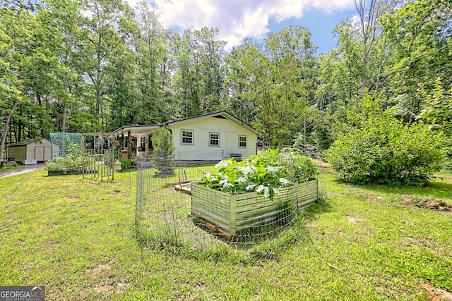 11 Hamilton Cir, Blairsville, GA 30512 - view of green lawn featuring a vegetable garden and a storage shed