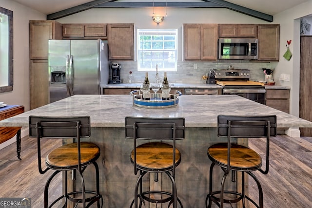 11 Hamilton Cir, Blairsville, GA 30512 - kitchen with appliances with stainless steel finishes, backsplash, light stone counters, a kitchen island, and a kitchen breakfast bar