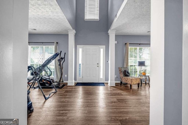 15 Saddlebrook Ct, Covington, GA 30016 - entryway featuring a textured ceiling, decorative columns, wood finished floors, and a high ceiling