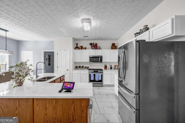 15 Saddlebrook Ct, Covington, GA 30016 - kitchen featuring stainless steel appliances, light marble finish floors, white cabinets, pendant lighting, and a textured ceiling