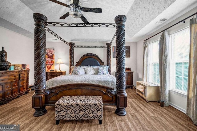 15 Saddlebrook Ct, Covington, GA 30016 - bedroom with a textured ceiling, wood finished floors, and ceiling fan