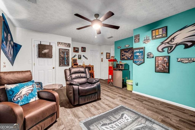 15 Saddlebrook Ct, Covington, GA 30016 - living area with wood finished floors, ceiling fan, and a textured ceiling