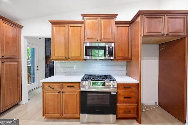 3292 Holly Mill Ct, Marietta, GA 30062 - kitchen with appliances with stainless steel finishes, light countertops, backsplash, and lofted ceiling