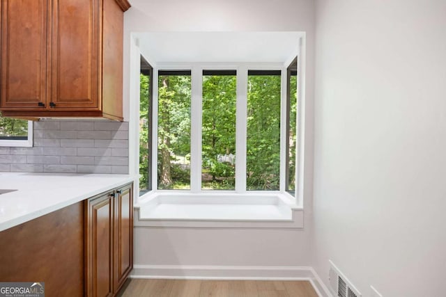 3292 Holly Mill Ct, Marietta, GA 30062 - bathroom featuring healthy amount of natural light, decorative backsplash, and wood finished floors
