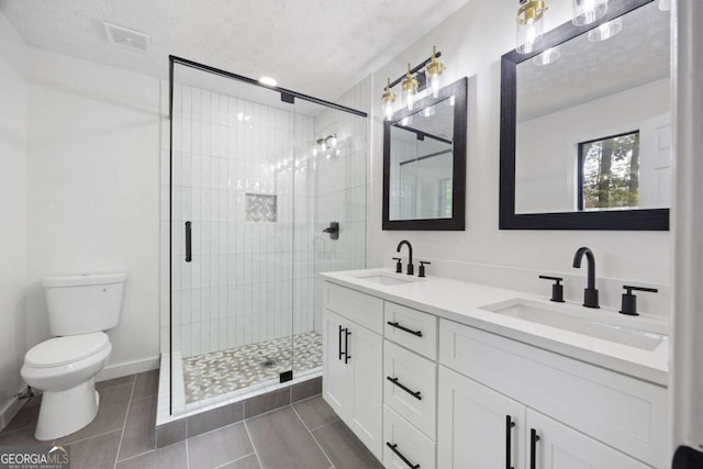 3292 Holly Mill Ct, Marietta, GA 30062 - bathroom featuring double vanity, a stall shower, tile patterned flooring, and a textured ceiling