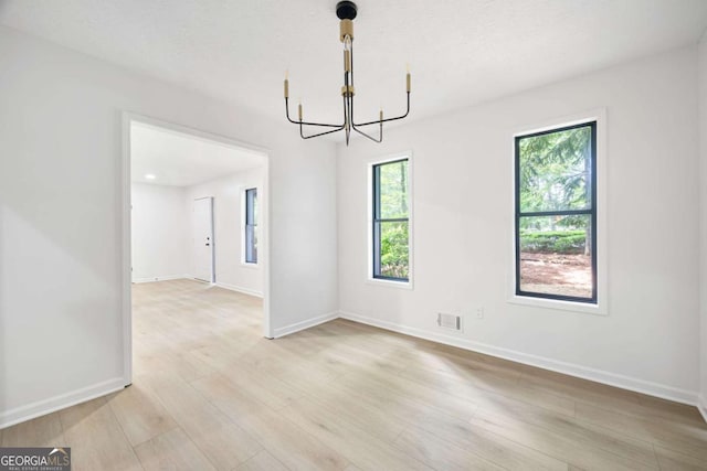 3292 Holly Mill Ct, Marietta, GA 30062 - spare room featuring a chandelier and light wood finished floors