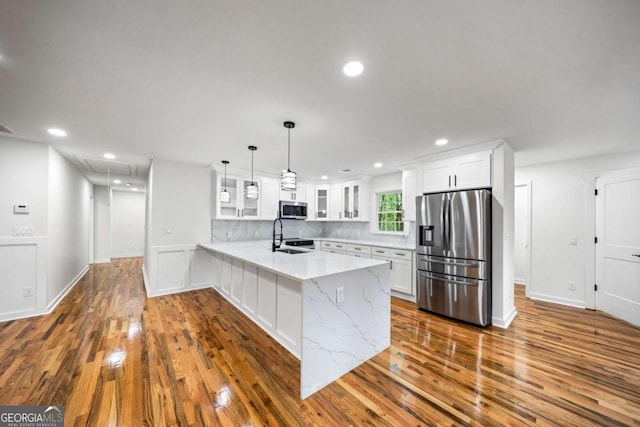 2798 Hutchins Rd, Lawrenceville, GA 30044 - kitchen featuring stainless steel appliances, a peninsula, glass insert cabinets, white cabinets, and recessed lighting