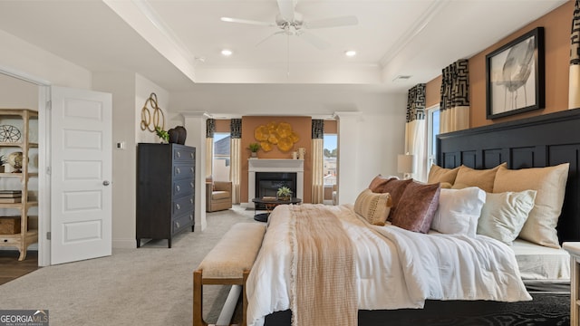 687 Edgar St Lot 83, Hampton, GA 30228 - bedroom with a tray ceiling, a glass covered fireplace, light colored carpet, recessed lighting, and a ceiling fan