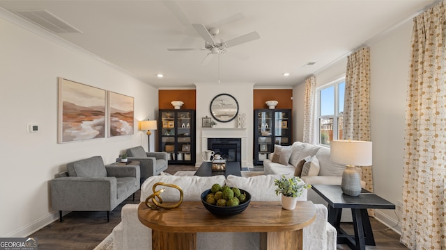 687 Edgar St Lot 83, Hampton, GA 30228 - living area featuring dark wood-style floors, ceiling fan, crown molding, a glass covered fireplace, and recessed lighting
