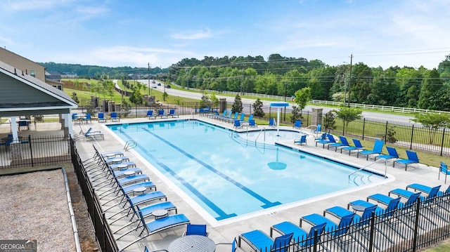 687 Edgar St Lot 83, Hampton, GA 30228 - community pool featuring a patio area and view of wooded area