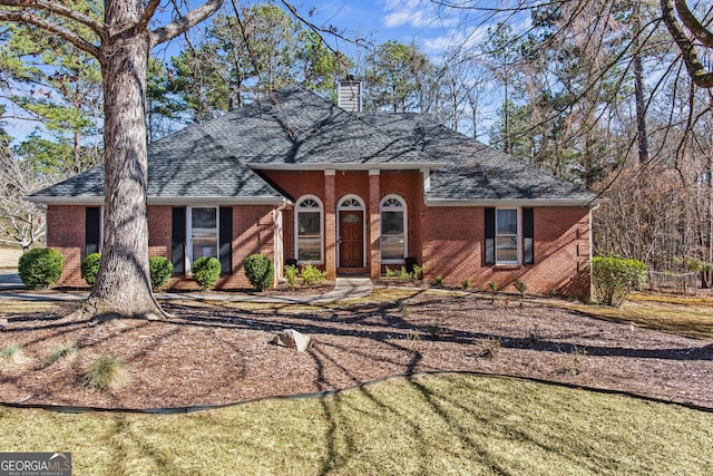 105 S Arcadia Dr, Bogart, GA 30622 - view of front facade featuring brick siding, roof with shingles, and a chimney