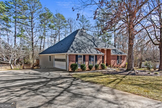 105 S Arcadia Dr, Bogart, GA 30622 - view of front of property with a garage, driveway, roof with shingles, and brick siding