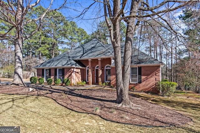 105 S Arcadia Dr, Bogart, GA 30622 - view of front facade featuring brick siding, a shingled roof, and a front lawn