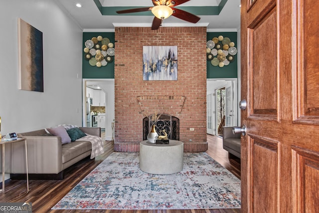 105 S Arcadia Dr, Bogart, GA 30622 - living room with ceiling fan, dark wood-type flooring, crown molding, and a brick fireplace