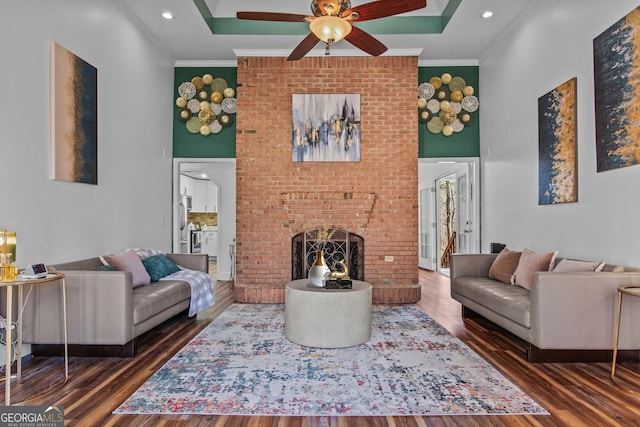 105 S Arcadia Dr, Bogart, GA 30622 - living room with a high ceiling, ceiling fan, wood finished floors, ornamental molding, and a brick fireplace