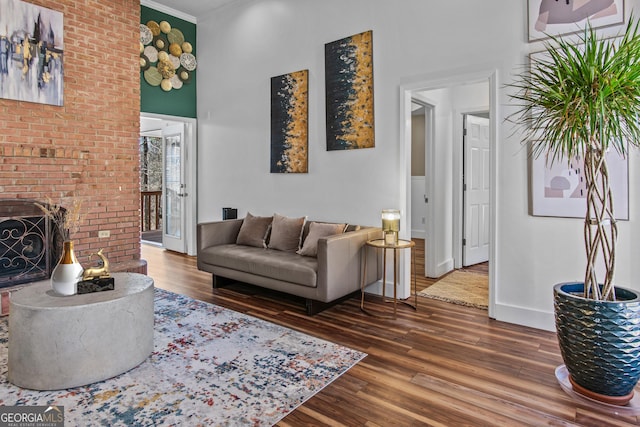 105 S Arcadia Dr, Bogart, GA 30622 - living area with wood finished floors, a towering ceiling, crown molding, and a brick fireplace
