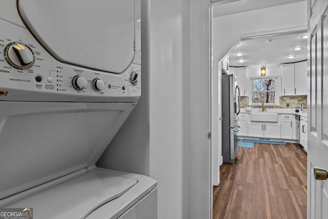 105 S Arcadia Dr, Bogart, GA 30622 - laundry room with estacked washer and dryer and dark wood-style flooring