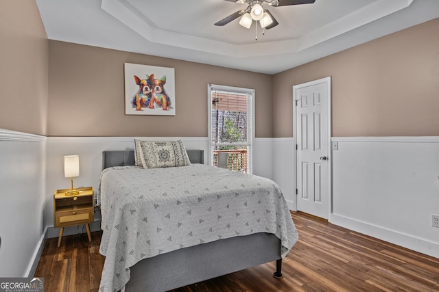 105 S Arcadia Dr, Bogart, GA 30622 - bedroom with a raised ceiling, wood finished floors, and a ceiling fan