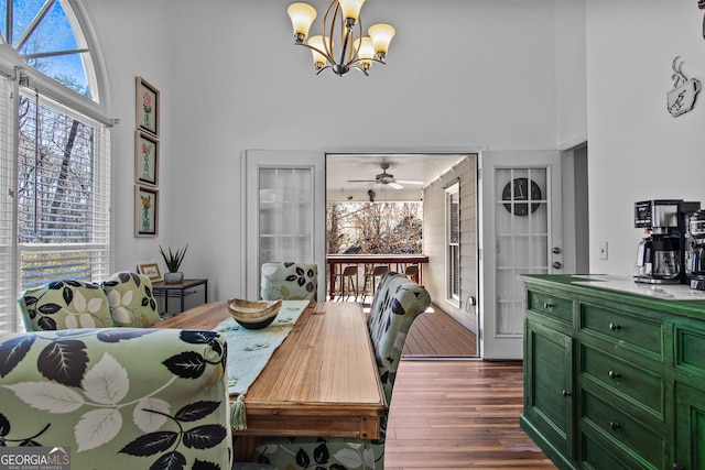 105 S Arcadia Dr, Bogart, GA 30622 - dining room with a high ceiling, a chandelier, dark wood finished floors, a ceiling fan, and built in shelves