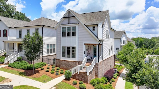 767 Farmstead Rd, Suwanee, GA 30024 - view of front facade featuring stairs, brick siding, and a shingled roof