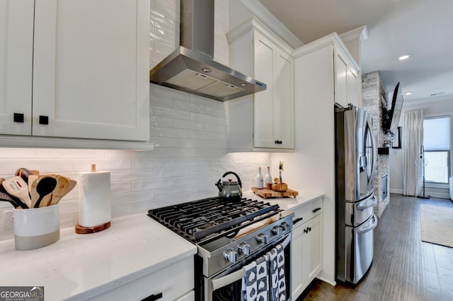 767 Farmstead Rd, Suwanee, GA 30024 - kitchen with wall chimney range hood, appliances with stainless steel finishes, decorative backsplash, white cabinets, and recessed lighting