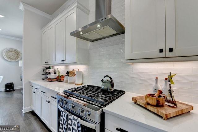 767 Farmstead Rd, Suwanee, GA 30024 - kitchen featuring wall chimney range hood, stainless steel range with gas stovetop, crown molding, tasteful backsplash, and white cabinetry
