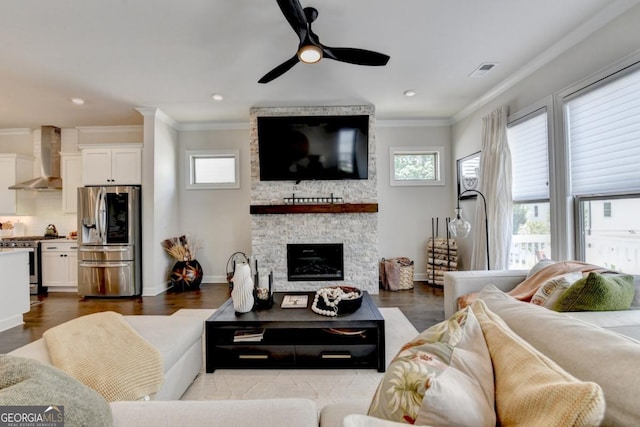 767 Farmstead Rd, Suwanee, GA 30024 - living room with ornamental molding, a ceiling fan, a stone fireplace, dark wood-style floors, and recessed lighting