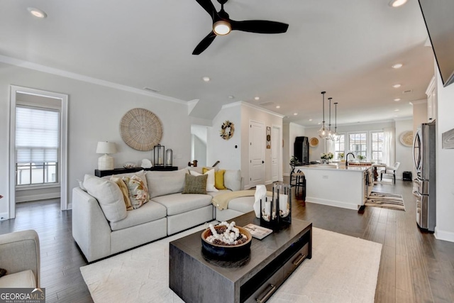 767 Farmstead Rd, Suwanee, GA 30024 - living room with ceiling fan, recessed lighting, ornamental molding, and dark wood finished floors
