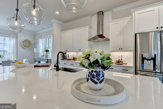 767 Farmstead Rd, Suwanee, GA 30024 - kitchen with wall chimney range hood, stainless steel fridge with ice dispenser, plenty of natural light, crown molding, and hanging light fixtures