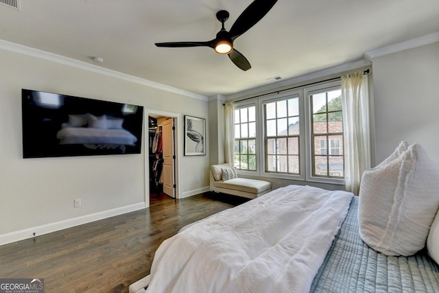767 Farmstead Rd, Suwanee, GA 30024 - bedroom with ornamental molding, wood finished floors, a walk in closet, ceiling fan, and a closet