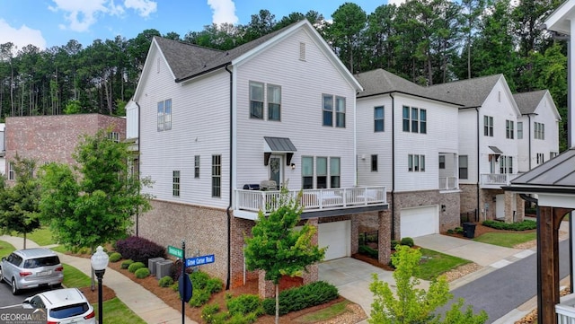 767 Farmstead Rd, Suwanee, GA 30024 - townhome / multi-family property with a garage, brick siding, and driveway