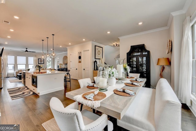 767 Farmstead Rd, Suwanee, GA 30024 - dining space with crown molding, ceiling fan, recessed lighting, and dark wood-style floors
