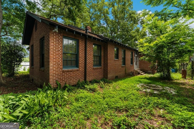 3105 Woodlawn Ave, Columbus, GA 31904 - view of property exterior with brick siding, entry steps, and a chimney